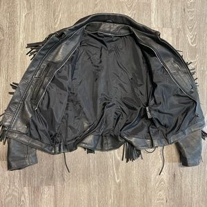 Vintage women’s leather coat with fringe and suede floral detail.